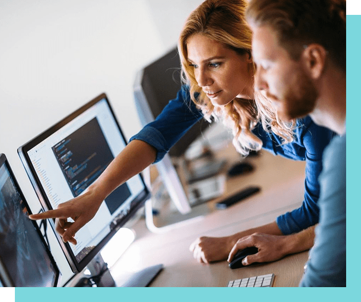 Two people are working on a computer.